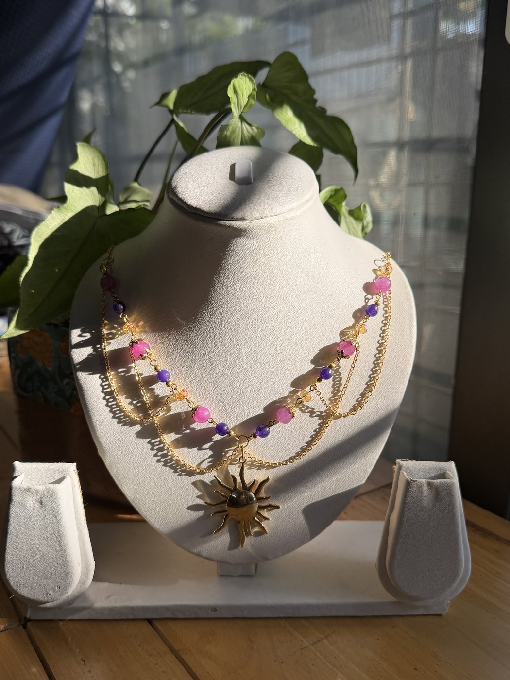 Emrys Craft necklace on a stand